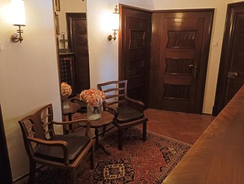 a dining room with a table and chairs and a door at Boutique hotel & Wellness Spitzerova vila Eliška in Janovice