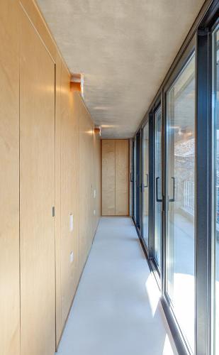 an empty hallway with large windows in a building at LASPI / PETRES in Pefkali