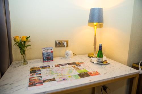 a table with a map and a lamp on it at City Pension Stephansplatz I Self Check In in Vienna