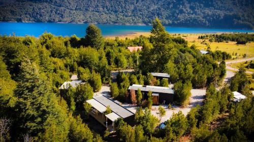 an aerial view of a house in a forest with a lake at Hermoso Loft en Lago Chapo con Hot Tub M1 in Puerto Montt
