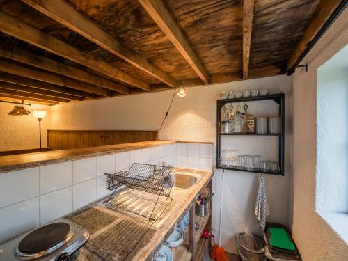 a kitchen with a sink and a counter top at Ventry Farm - The Parlour Cottage in Ventry