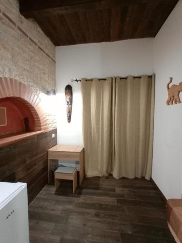 a kitchen with a shower curtain in a room at Big Mama Jungle Rooms in Terracina