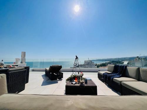 a living room with couches and a view of the ocean at V Penthouse in Vieste