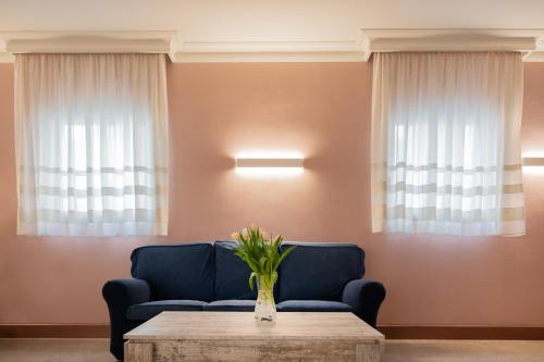 a living room with two blue chairs and a table at Hotel Diana in Ravenna