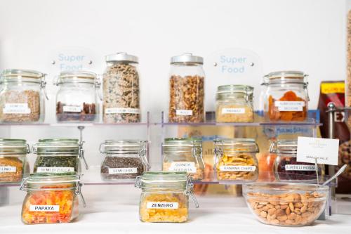a shelf filled with jars of different types of food at Hotel Diana in Ravenna