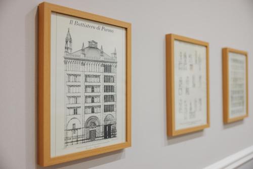 a framed picture of a building on a wall at Palazzo Dalla Rosa Prati in Parma