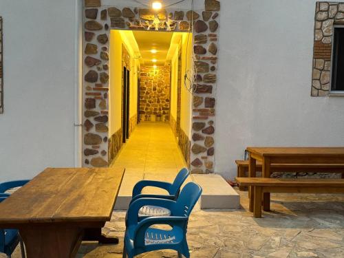 a hallway with wooden tables and blue chairs in a building at Zen house in Kas