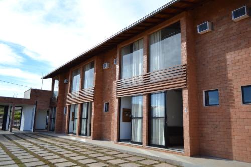 a brick building with large windows on the side at Chalés Belo Vale - Tiradentes in Tiradentes
