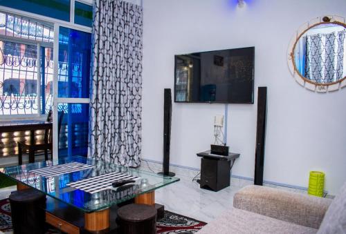 a living room with a glass table and a couch at SUNCOAST HOMES in Mtwapa