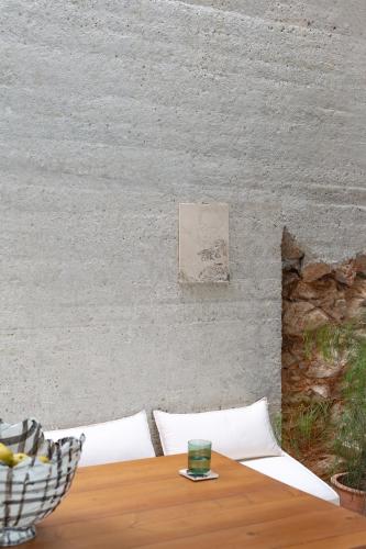 a table with a glass on top of it next to a wall at LASPI / PETRES in Pefkali