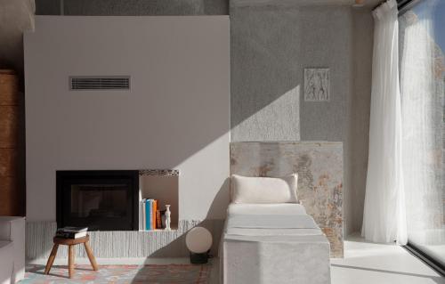 a living room with a couch and a fireplace at LASPI / PETRES in Pefkali
