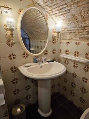 a bathroom with a sink and a mirror at Il Cortile nel Borgo in Lanciano