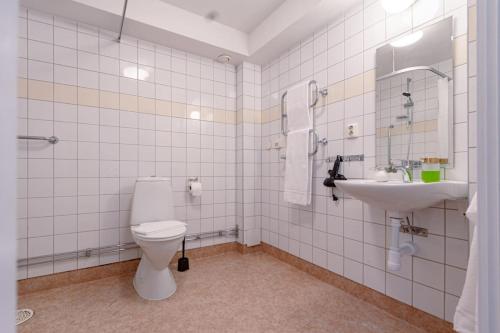 a bathroom with a toilet and a sink at Sodermalm Hideaway Haven in Stockholm
