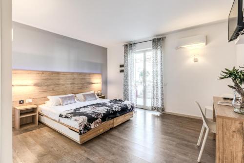 a bedroom with a bed with a wooden headboard at Casena Dei Colli, Sure Hotel Collection By Best Western in Palermo