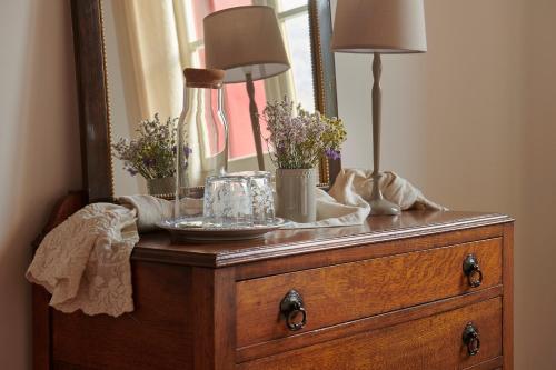 a dresser with a mirror and a lamp on it at Villa Lovi in Bassano del Grappa
