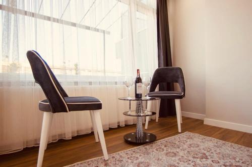 two chairs and a table with a bottle of wine at Hodegon Suite Hotel in Istanbul