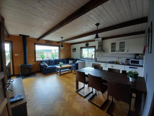 a kitchen and living room with a table and a couch at Ristafallet in Åre