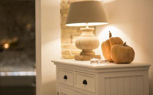 a table with a lamp and pumpkins on it at Residenza Amblingh in Vasto