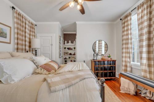 a bedroom with a bed and a ceiling fan at Southern Belle on Oglethorpe Square in Savannah
