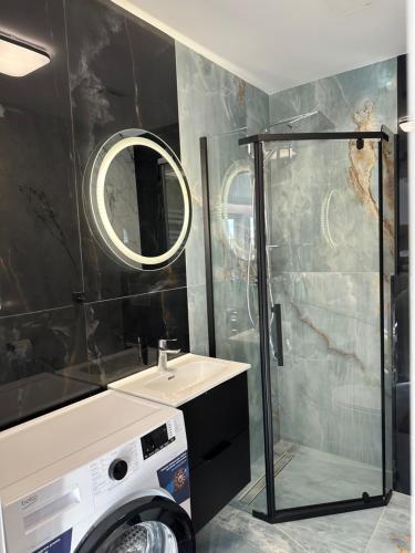 a bathroom with a washing machine and a sink at MOVEEN! Wynajem apartamentów we Wrocławiu! 10 minut od centrum in Wrocław