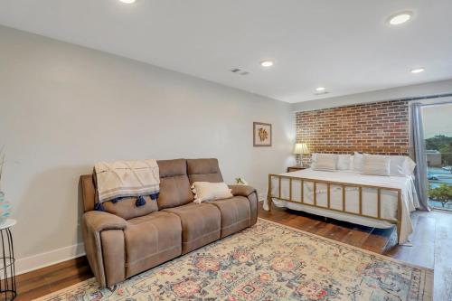 a living room with a couch and a bed at The Post Suite - above Bull & Barrel Close to GSU in Statesboro