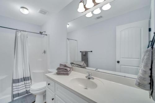a white bathroom with a sink and a toilet at GATA Suite - Quiet neighborhood 10 minutes to GSU in Statesboro