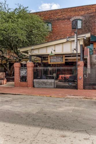 a building with a fence in front of a restaurant at West End Loft - Downtown 5 min walk to River St in Savannah