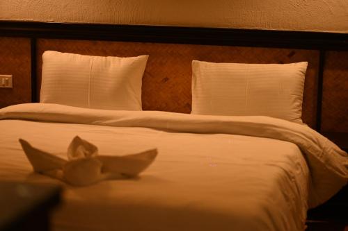 a bedroom with two beds with white sheets at Red Panda Jungle Camp - A Unit of Davinchi Homes Pvt Ltd in Gyalzing