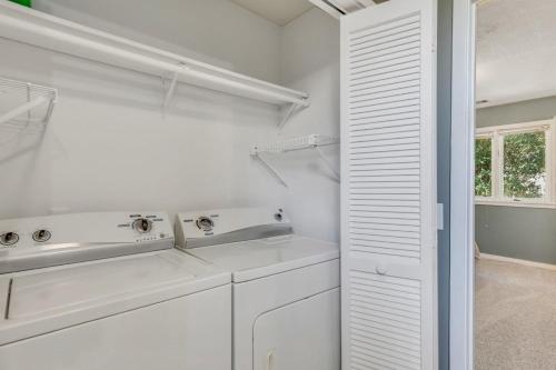 a white laundry room with a washer and dryer at GATA 2 -The Rustic Suite - Close to GSU in Statesboro