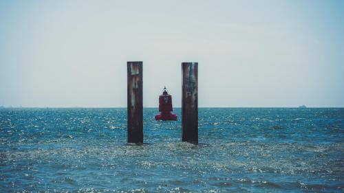 a lighthouse in the middle of a body of water at Hotel Restaurant Solskin in Vlissingen