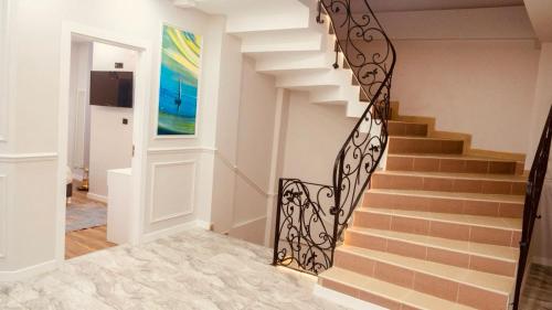 una escalera en una casa con barandilla de hierro forjado en Hodegon Suite Hotel, en Estambul
