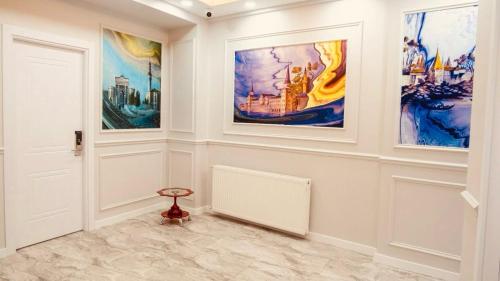 a room with paintings on the walls and a door at Hodegon Suite Hotel in Istanbul