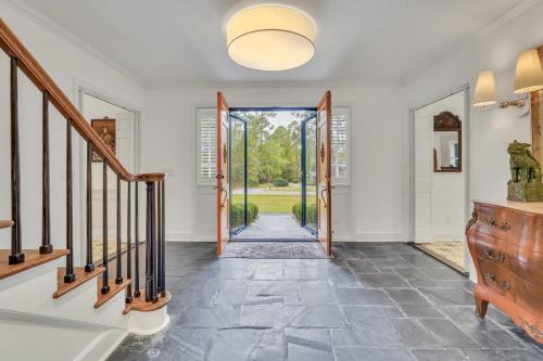 a hallway with a door leading to a yard at The Grey - Large Eclectic and Quiet Home in Statesboro