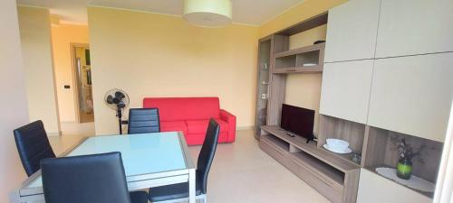 a living room with a table and a red couch at Antico Principato di Seborga in Vallebona