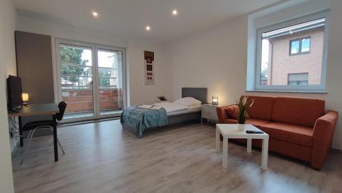 a living room with a couch and a bed at Dammstraße 24-EG-ZV38 in Salzgitter