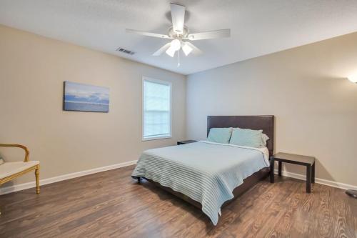 a bedroom with a bed and a ceiling fan at Cozy and Contemporary Villa 1 Mile from GSU in Statesboro