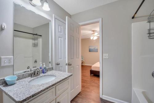 a bathroom with a sink and a mirror at Cozy and Contemporary Villa 1 Mile from GSU in Statesboro