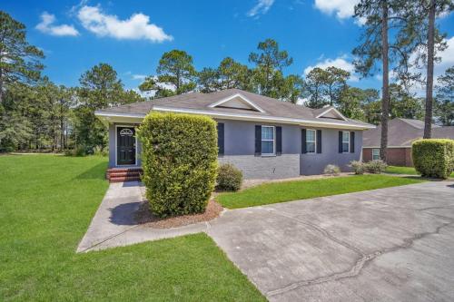 a home in the suburbs with a driveway at Cozy and Contemporary Villa 1 Mile from GSU in Statesboro