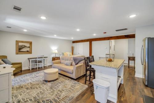 a kitchen and living room with a couch and a table at Eagle Exec Loft In Downtown Statesboro in Statesboro