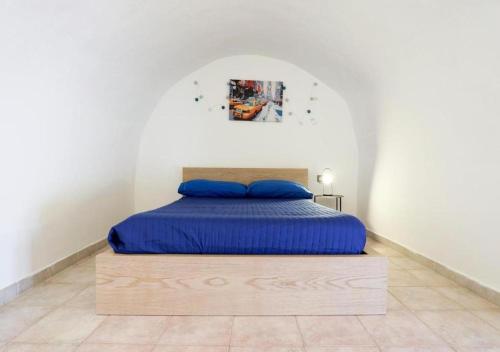 a bed with a wooden frame in a room at La Tata home in Salerno