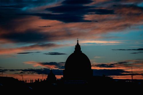a silhouette of a building under a cloudy sky at Twentyone Hotel in Rome