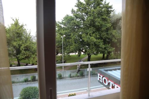 a window with a view of a street and trees at Hotel Pogradeci in Pogradec