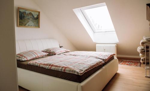a bedroom with a bed with a large window at Ferienwohnung Prof. Dehmer in Zell im Fichtelgebirge