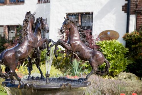 a statue of a horse in front of a fountain at Western House Hotel in Ayr
