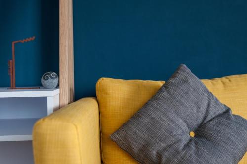a yellow couch with a pillow in a room at Port Aran House in Kilronan