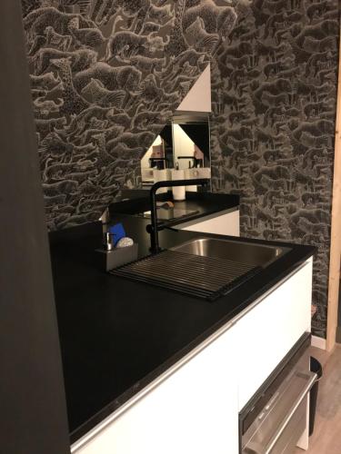 a kitchen with a black counter and a mirror at donibane20 EBI02770 in Orduña