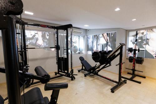 a room with a gym with several tread machines at Tonello Business Hotel in Campo Mourão