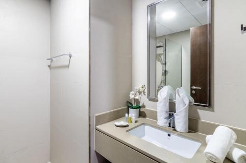 a bathroom with a sink and a mirror at Silkhaus Dubai Financial Center studio in Burj Daman in Dubai