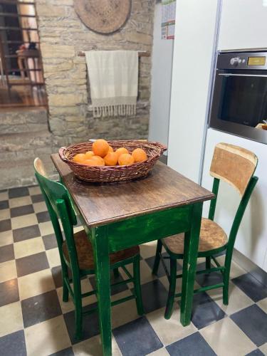 a bowl of oranges on a table in a kitchen at Bissantica, heritage and charm in rural Sardinia in Lunamatrona