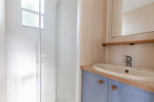 a bathroom with a shower and a sink at Camping maeva Club Royal Océan in Saint-Sulpice-de-Royan
